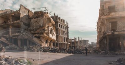 Destroyed buildings in conflict zone, representing regional instability and the need for safe relocation through citizenship by investment